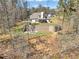 Home's backyard with a brick retaining wall and an outdoor fire pit area at 180 Allie Dr, Mcdonough, GA 30252