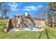 The backyard features a brick patio with a fire pit surrounded by Adirondack chairs at 180 Allie Dr, Mcdonough, GA 30252
