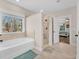 Bright bathroom featuring a shower and tub combination with tan tile accents at 180 Allie Dr, Mcdonough, GA 30252