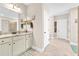 Neutral toned bathroom with double doors, dual sinks and granite countertops at 180 Allie Dr, Mcdonough, GA 30252
