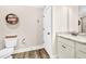 Cozy bathroom with white and granite vanity, hardwood floors, and decor at 180 Allie Dr, Mcdonough, GA 30252