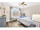 Bright bedroom features hardwood floors, and large picture window with curtains at 180 Allie Dr, Mcdonough, GA 30252