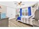 Bright bedroom with hardwood floors, large picture window, and ceiling fan at 180 Allie Dr, Mcdonough, GA 30252