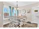 Cozy eat-in kitchen with wooden table, chairs, pendant lighting, and view of the lake at 180 Allie Dr, Mcdonough, GA 30252