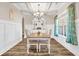 Formal dining room featuring wainscoting, coffered ceiling and stylish furnishings at 180 Allie Dr, Mcdonough, GA 30252