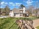 View of the home's exterior featuring a spacious yard, brick facade and outdoor patio at 180 Allie Dr, Mcdonough, GA 30252