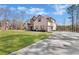 A two-story brick house with a long drive, a well-kept lawn, and mature trees at 180 Allie Dr, Mcdonough, GA 30252