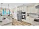 Modern kitchen with stainless steel appliances, white cabinets, breakfast bar, and stylish countertops at 180 Allie Dr, Mcdonough, GA 30252