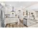 Bright kitchen features stainless steel appliances, white cabinetry, stone counters and modern fixtures at 180 Allie Dr, Mcdonough, GA 30252