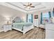 Large primary bedroom with tray ceiling, ceiling fan, luxury furniture, and lots of natural light at 180 Allie Dr, Mcdonough, GA 30252