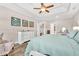 Bright main bedroom features a ceiling fan, tray ceiling, and hardwood floors at 180 Allie Dr, Mcdonough, GA 30252