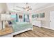Spacious primary bedroom with tray ceiling, ceiling fan, luxury furniture and lots of natural light at 180 Allie Dr, Mcdonough, GA 30252