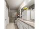 Bathroom featuring double sink vanity and walk-in shower with glass door at 230 Rosenwald Ln, Hampton, GA 30228