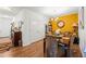 Charming dining area featuring a decorative accent wall and hardwood flooring at 230 Rosenwald Ln, Hampton, GA 30228