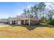 Beautiful brick home with covered porch, well-manicured lawn, and inviting curb appeal at 230 Rosenwald Ln, Hampton, GA 30228