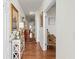 Inviting hallway with hardwood floors, decorative art, and neutral paint at 230 Rosenwald Ln, Hampton, GA 30228