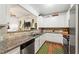 Modern kitchen with granite countertops, stainless steel appliances, and white cabinets at 230 Rosenwald Ln, Hampton, GA 30228