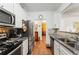 Stylish kitchen featuring stainless steel appliances, granite countertops, and ample cabinet space at 230 Rosenwald Ln, Hampton, GA 30228