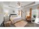 Spacious main bedroom with tray ceiling, neutral tones, and comfortable furnishings at 230 Rosenwald Ln, Hampton, GA 30228