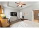 Bright main bedroom with stylish decor, tray ceilings, and ensuite bathroom access at 230 Rosenwald Ln, Hampton, GA 30228