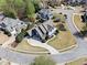 Aerial view of a beautiful home with a well-manicured lawn, a circular driveway, and mature trees at 302 Meadow Lark Xing, Canton, GA 30114
