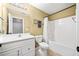 Traditional bathroom featuring a standard tub, tiled shower, and a white vanity with decorative hardware at 302 Meadow Lark Xing, Canton, GA 30114