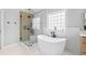 Contemporary bathroom featuring a standalone tub and glass-enclosed shower at 302 Meadow Lark Xing, Canton, GA 30114