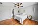 Bedroom with hardwood floors, a ceiling fan, doorway to a full bathroom, and neutral colors at 302 Meadow Lark Xing, Canton, GA 30114
