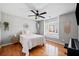 Bedroom features wood floors, a ceiling fan, a white comforter, and a window with natural light at 302 Meadow Lark Xing, Canton, GA 30114