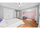 Bright bedroom featuring hardwood floors, grey walls, white trim, and a unique bonus room/playroom at 302 Meadow Lark Xing, Canton, GA 30114