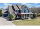 Lovely home with attached garage, lush lawn, stone accents and cozy front porch with rocking chairs at 302 Meadow Lark Xing, Canton, GA 30114