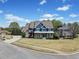Beautiful two-story home with stone accents, inviting front porch, and spacious lawn on a landscaped corner lot at 302 Meadow Lark Xing, Canton, GA 30114