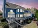 Two-story home with a large deck and a staircase that leads to the backyard at 302 Meadow Lark Xing, Canton, GA 30114