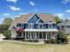 Charming two-story home featuring a welcoming front porch, manicured lawn and a combination of stone and siding at 302 Meadow Lark Xing, Canton, GA 30114