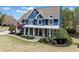 Inviting two-story home with manicured front yard and stone accents, perfect for relaxing on the charming porch at 302 Meadow Lark Xing, Canton, GA 30114