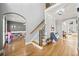 Bright foyer with hardwood floors, staircase with decorative iron spindles, and arched doorways at 302 Meadow Lark Xing, Canton, GA 30114