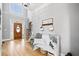 Bright foyer with hardwood floors, staircase, decorated bench and view of front door at 302 Meadow Lark Xing, Canton, GA 30114