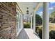 Stone facade porch with white columns and trim, showing a welcoming outdoor space at 302 Meadow Lark Xing, Canton, GA 30114