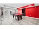 Game room featuring a red accent wall and a full-sized pool table, perfect for entertaining at 302 Meadow Lark Xing, Canton, GA 30114