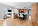 Spacious kitchen with island, stone fireplace, stainless appliances, hardwood floors, and breakfast bar seating at 302 Meadow Lark Xing, Canton, GA 30114
