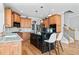 Island kitchen with black countertop and hardwood floors and stairway access at 302 Meadow Lark Xing, Canton, GA 30114