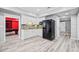 Basement kitchenette with white cabinets, granite countertops, and stainless steel appliances, next to game room at 302 Meadow Lark Xing, Canton, GA 30114