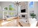 Sunlit living room with stone fireplace, hardwood floors, and large windows at 302 Meadow Lark Xing, Canton, GA 30114