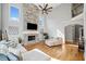 Bright living room featuring a stone fireplace, hardwood floors, and expansive windows at 302 Meadow Lark Xing, Canton, GA 30114