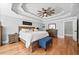Spacious main bedroom with tray ceiling, hardwood floors, and neutral decor at 302 Meadow Lark Xing, Canton, GA 30114