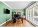 Green office with large window, desk, and TV, perfect for working from home at 302 Meadow Lark Xing, Canton, GA 30114