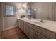 Bright bathroom featuring a long vanity with double sinks and natural light at 3020 Templeton Ln, Loganville, GA 30052