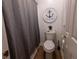 Cozy bathroom with nautical décor, a gray shower curtain, and neutral-toned walls at 3020 Templeton Ln, Loganville, GA 30052