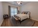 Bedroom with a metal frame bed, natural light, and a cozy sitting area at 3020 Templeton Ln, Loganville, GA 30052