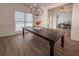 Dining room with wood flooring, a rustic table, and a view to the entry and office at 3020 Templeton Ln, Loganville, GA 30052